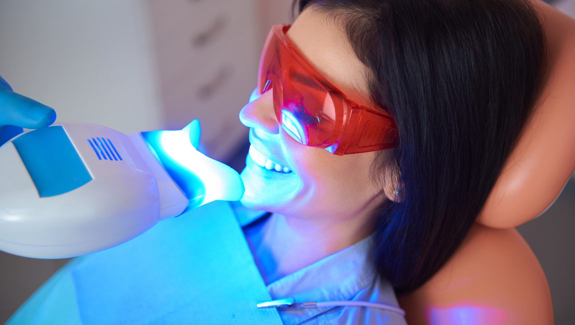 Patient receiving professional Zoom teeth whitening with LED light at our Costa Mesa dental office