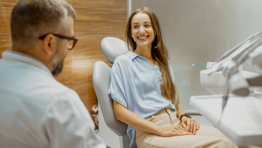 Dentist discussing porcelain veneer options with a patient at our Costa Mesa office