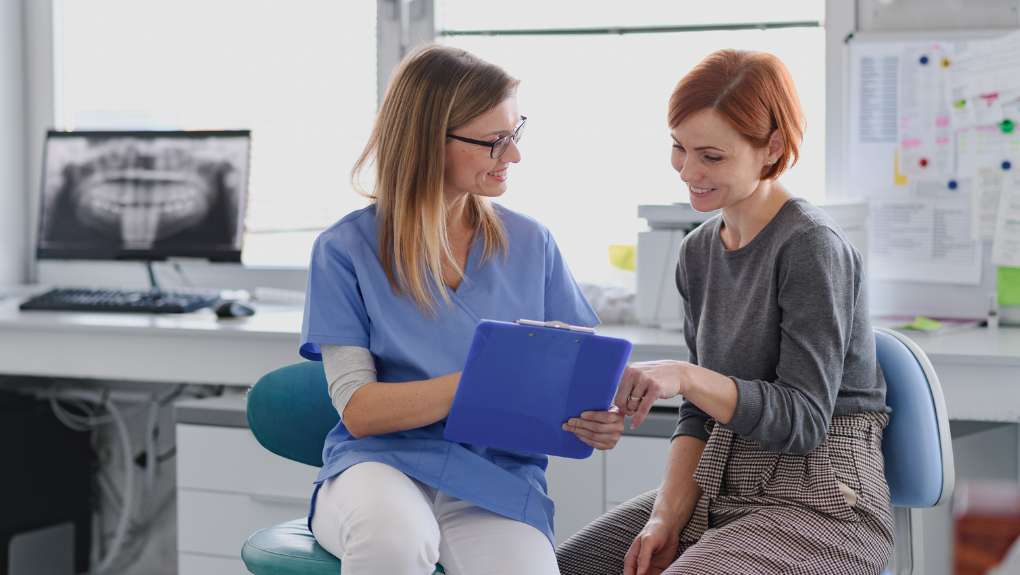 Dentist reviewing a dental crown treatment plan with a patient at our Costa Mesa office