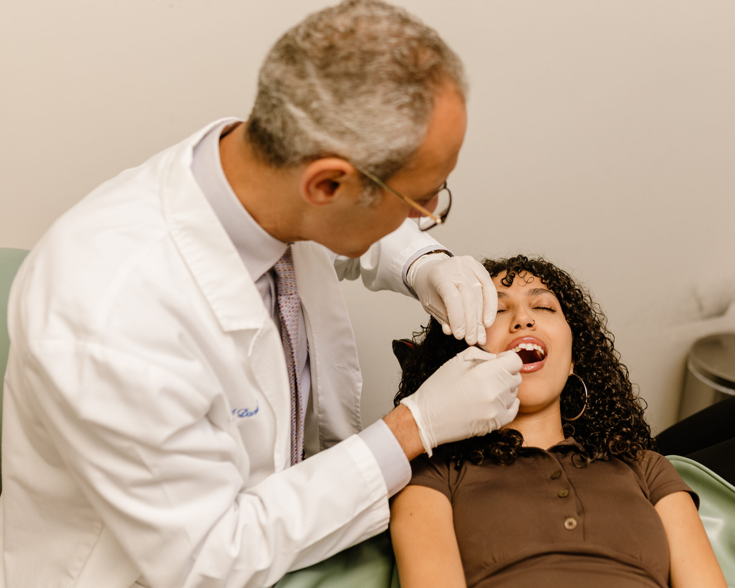 Dentist providing gentle dental treatment to a patient at our Costa Mesa office