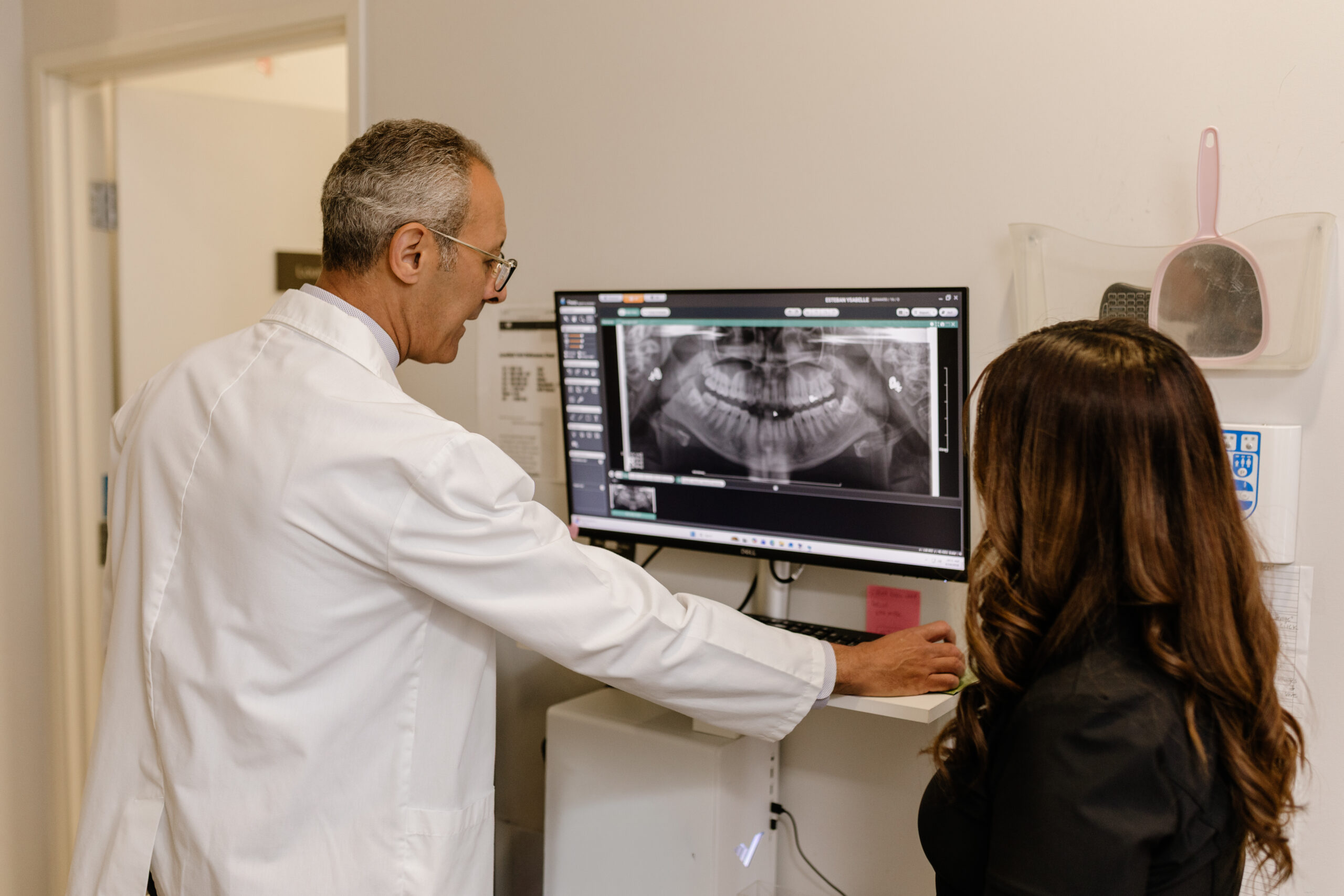 Dentist reviewing a digital X-ray on screen together with a patient at Brite Clean Smiles